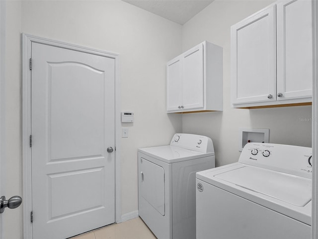 15647 Braintree Ln, Winter Garden, FL 34787 - laundry area featuring separate washer and dryer, cabinet space, and light tile patterned flooring