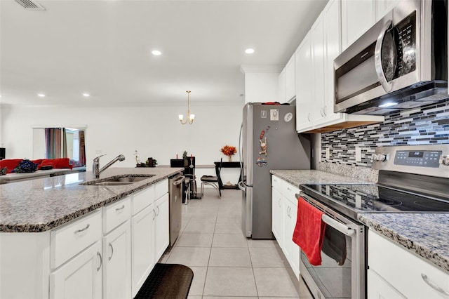 804 Glen Creek Ct, Fruitland Park, FL 34731 - kitchen with appliances with stainless steel finishes, a sink, light tile patterned flooring, tasteful backsplash, and ornamental molding