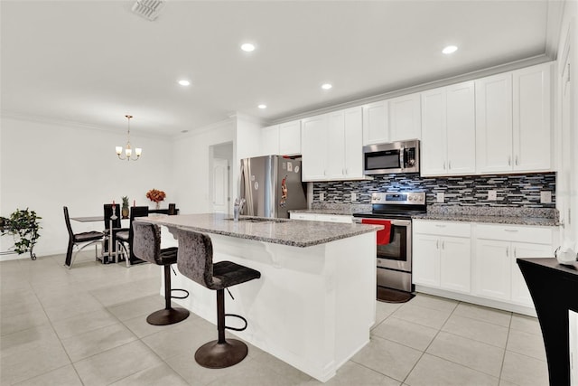 804 Glen Creek Ct, Fruitland Park, FL 34731 - kitchen featuring appliances with stainless steel finishes, ornamental molding, decorative backsplash, light tile patterned floors, and white cabinetry