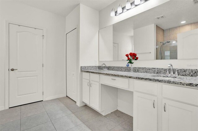 804 Glen Creek Ct, Fruitland Park, FL 34731 - full bathroom featuring double vanity, a shower stall, tile patterned floors, and baseboards