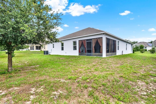 804 Glen Creek Ct, Fruitland Park, FL 34731 - back of house featuring a sunroom, a yard, central AC, and stucco siding