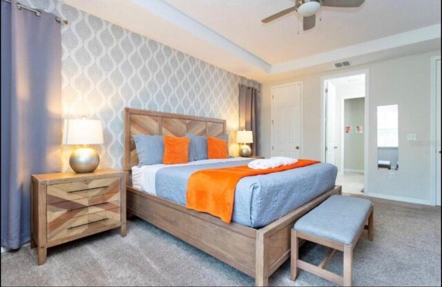 1625 Nassau Point Trl, Kissimmee, FL 34747 - bedroom featuring carpet flooring, baseboards, a ceiling fan, and wallpapered walls