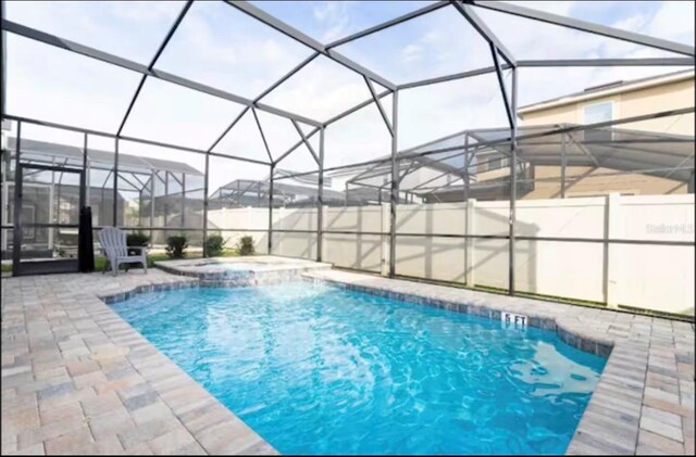 1625 Nassau Point Trl, Kissimmee, FL 34747 - view of pool with a patio area, a pool with connected hot tub, and a lanai