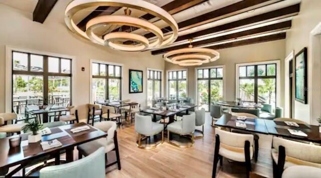 1625 Nassau Point Trl, Kissimmee, FL 34747 - dining space with beamed ceiling and light wood-type flooring