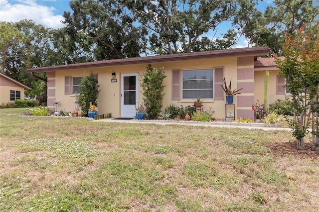 4549 Tippecanoe Trl Unit 20, Sarasota, FL 34233 - ranch-style house with stucco siding and a front yard