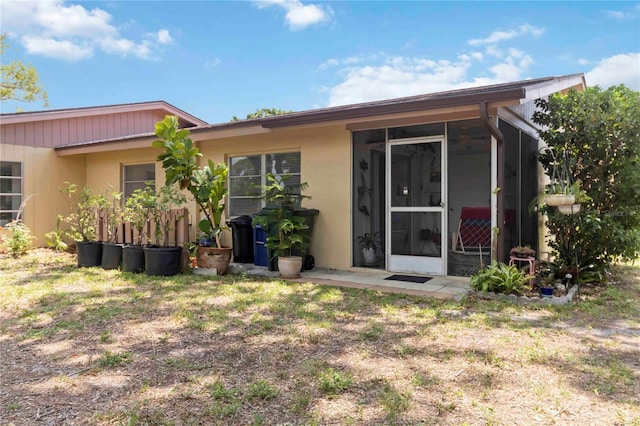 4549 Tippecanoe Trl Unit 20, Sarasota, FL 34233 - back of house featuring a sunroom and stucco siding