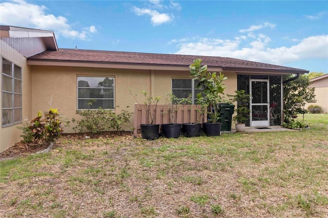 4549 Tippecanoe Trl Unit 20, Sarasota, FL 34233 - back of house with a yard, stucco siding, and a sunroom