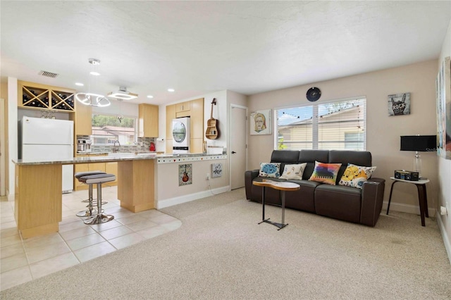 4549 Tippecanoe Trl Unit 20, Sarasota, FL 34233 - living area with light colored carpet, baseboards, plenty of natural light, washer / dryer, and recessed lighting