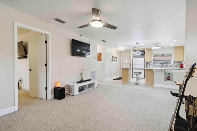 4549 Tippecanoe Trl Unit 20, Sarasota, FL 34233 - living area featuring a ceiling fan, light colored carpet, and baseboards