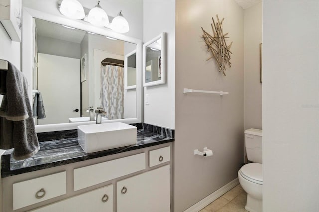 4549 Tippecanoe Trl Unit 20, Sarasota, FL 34233 - full bath with toilet, vanity, tile patterned floors, and baseboards