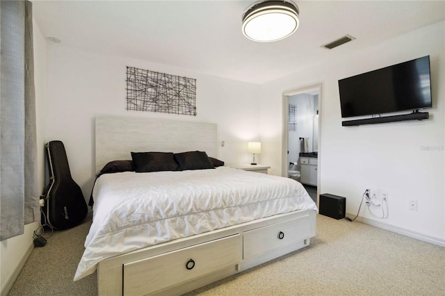 4549 Tippecanoe Trl Unit 20, Sarasota, FL 34233 - bedroom with carpet, ensuite bathroom, and baseboards