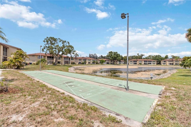 4549 Tippecanoe Trl Unit 20, Sarasota, FL 34233 - view of property's community featuring shuffleboard, a lawn, and a residential view
