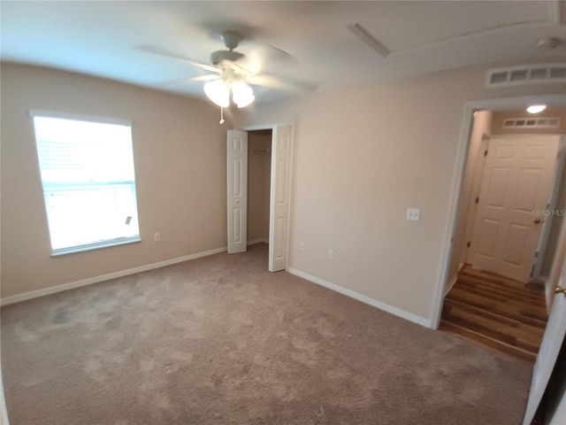 2555 Palmetto Ridge Cir, Apopka, FL 32712 - unfurnished bedroom with carpet flooring, ceiling fan, and a closet