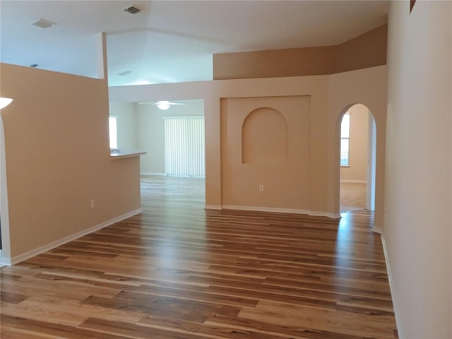 2555 Palmetto Ridge Cir, Apopka, FL 32712 - unfurnished room featuring arched walkways, wood finished floors, ceiling fan, and high vaulted ceiling