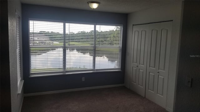 5160 Conroy Rd Unit 1437, Orlando, FL 32811 - unfurnished bedroom featuring carpet floors, a closet, and baseboards