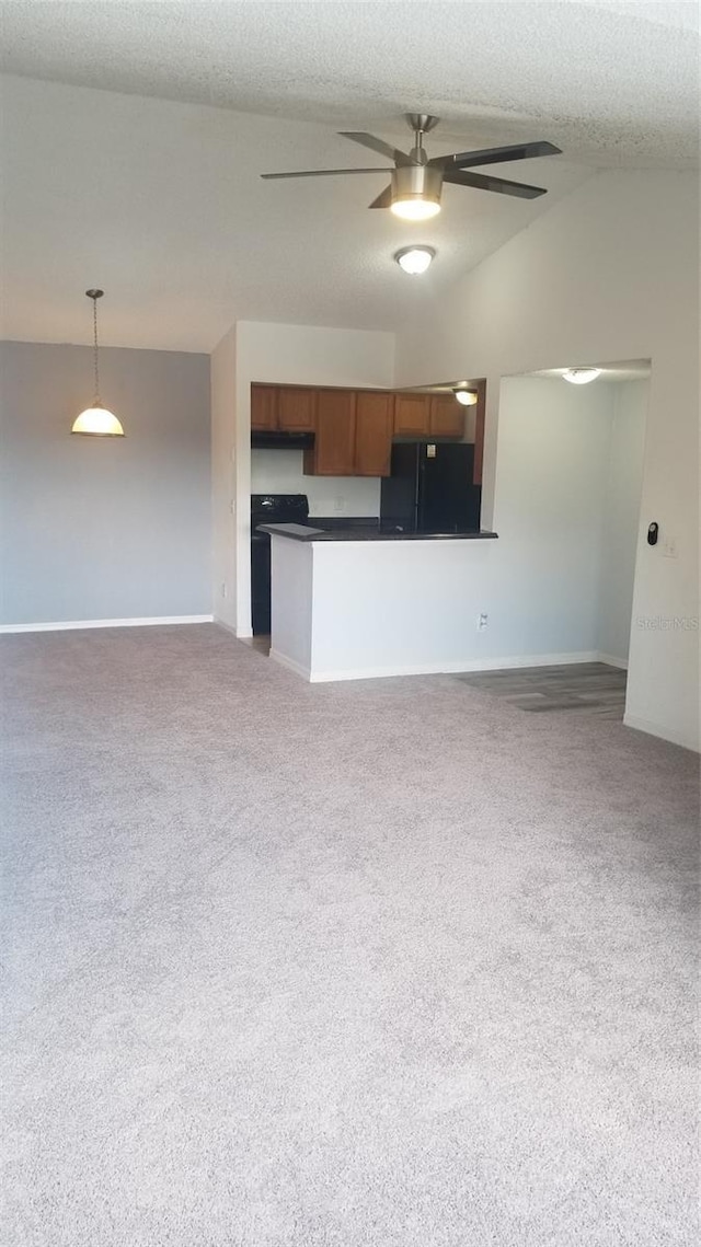 5160 Conroy Rd Unit 1437, Orlando, FL 32811 - kitchen featuring freestanding refrigerator, dark countertops, open floor plan, vaulted ceiling, and baseboards
