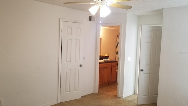 5160 Conroy Rd Unit 1437, Orlando, FL 32811 - unfurnished bedroom with light colored carpet, connected bathroom, and a ceiling fan