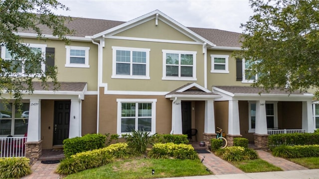 15693 Kinnow Mandarin Ln, Winter Garden, FL 34787 - view of property with a porch, stucco siding, and roof with shingles