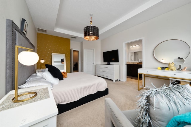 15693 Kinnow Mandarin Ln, Winter Garden, FL 34787 - bedroom featuring light colored carpet, a raised ceiling, and ensuite bathroom