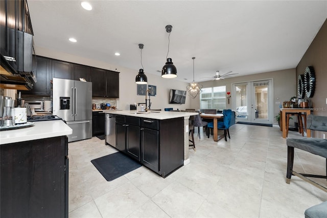 15693 Kinnow Mandarin Ln, Winter Garden, FL 34787 - kitchen featuring appliances with stainless steel finishes, tasteful backsplash, light countertops, recessed lighting, and a kitchen island with sink