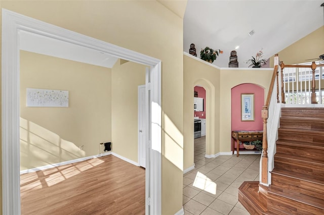 8113 Sun Palm Dr, Kissimmee, FL 34747 - foyer entrance with arched walkways, stairs, tile patterned floors, baseboards, and ceiling fan