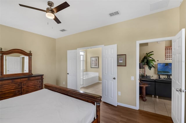 8113 Sun Palm Dr, Kissimmee, FL 34747 - bedroom with wood finished floors, ensuite bath, and baseboards
