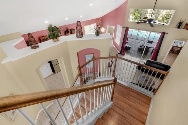 8113 Sun Palm Dr, Kissimmee, FL 34747 - staircase featuring a high ceiling, ceiling fan, wood finished floors, recessed lighting, and arched walkways