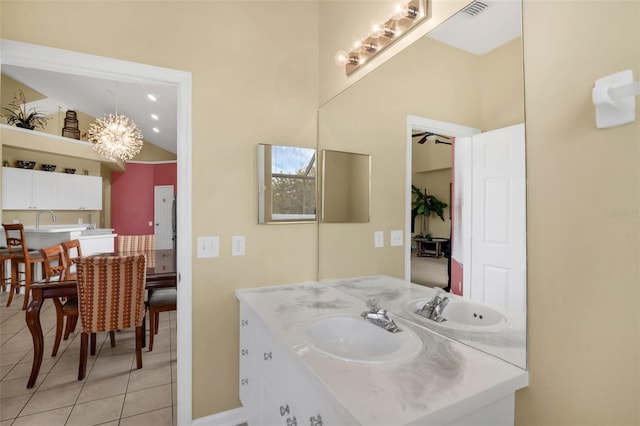 8113 Sun Palm Dr, Kissimmee, FL 34747 - bathroom with tile patterned floors, vanity, a chandelier, high vaulted ceiling, and baseboards