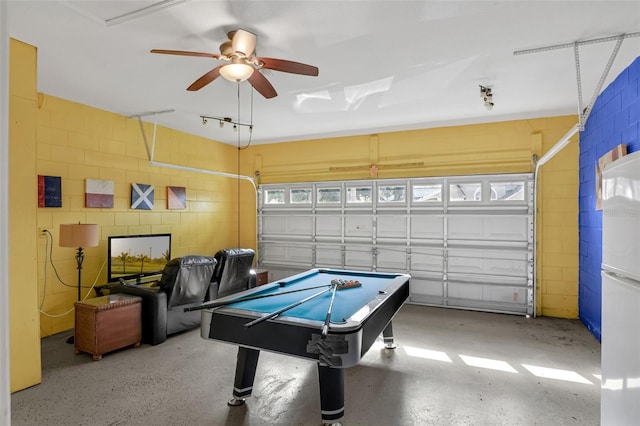 8113 Sun Palm Dr, Kissimmee, FL 34747 - game room with a ceiling fan, concrete block wall, and a garage