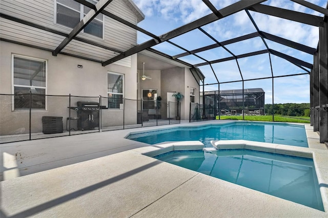 8113 Sun Palm Dr, Kissimmee, FL 34747 - view of swimming pool with a patio area, ceiling fan, a pool with connected hot tub, a lanai, and area for grilling