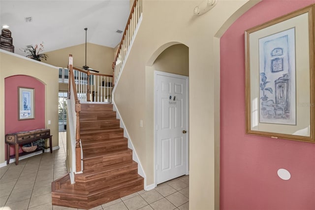 8113 Sun Palm Dr, Kissimmee, FL 34747 - stairs with tile patterned floors, baseboards, arched walkways, lofted ceiling, and a ceiling fan