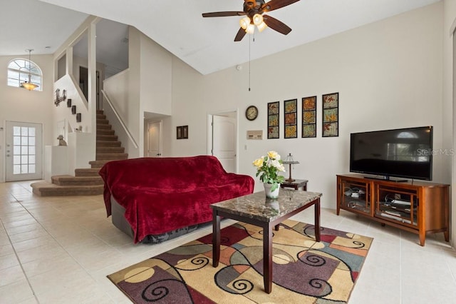 3018 Bransbury Ct, Kissimmee, FL 34747 - living room with high vaulted ceiling, tile patterned flooring, ceiling fan, and stairway