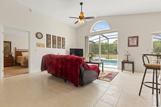 3018 Bransbury Ct, Kissimmee, FL 34747 - living area with light tile patterned flooring, lofted ceiling, and a ceiling fan