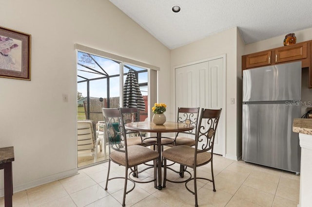 3018 Bransbury Ct, Kissimmee, FL 34747 - dining space featuring lofted ceiling, light tile patterned floors, and baseboards