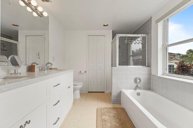 3018 Bransbury Ct, Kissimmee, FL 34747 - full bathroom featuring double vanity, a garden tub, tile patterned flooring, toilet, and a tile shower