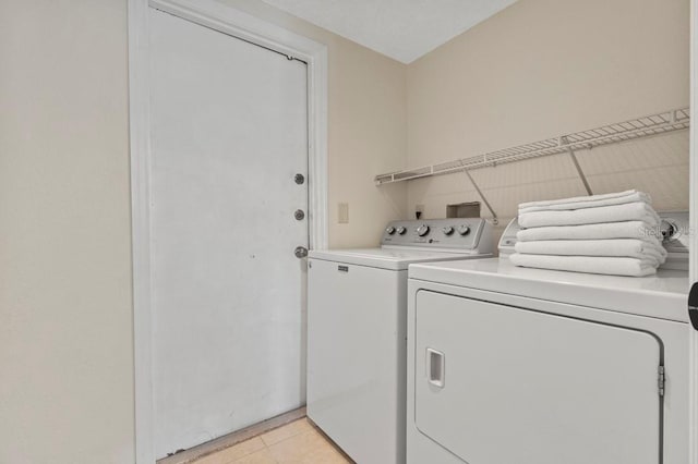 3018 Bransbury Ct, Kissimmee, FL 34747 - laundry area featuring light tile patterned floors and washer and dryer