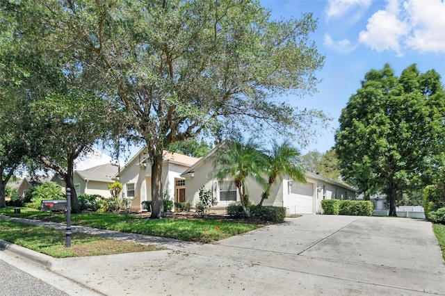 2674 Spicebush Loop, Apopka, FL 32712 - view of front of property featuring a garage, concrete driveway, stucco siding, and a front lawn