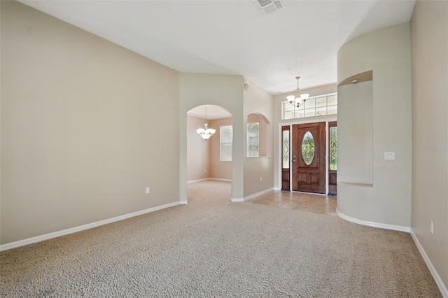 2674 Spicebush Loop, Apopka, FL 32712 - carpeted entryway featuring a chandelier, baseboards, arched walkways, and a towering ceiling