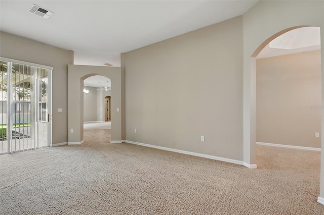 2674 Spicebush Loop, Apopka, FL 32712 - empty room with arched walkways, light colored carpet, and baseboards