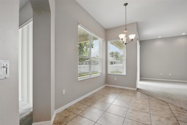2674 Spicebush Loop, Apopka, FL 32712 - unfurnished dining area featuring light tile patterned floors, baseboards, a chandelier, and light colored carpet