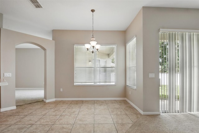 2674 Spicebush Loop, Apopka, FL 32712 - spare room with arched walkways, a chandelier, light tile patterned floors, and baseboards