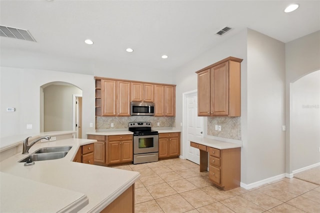 2674 Spicebush Loop, Apopka, FL 32712 - kitchen featuring stainless steel appliances, a sink, arched walkways, light tile patterned flooring, and recessed lighting