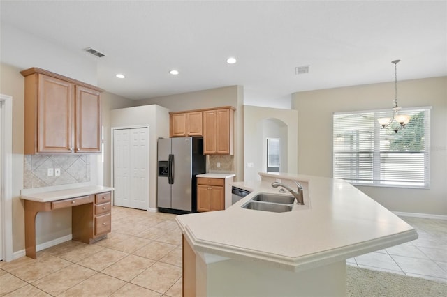 2674 Spicebush Loop, Apopka, FL 32712 - kitchen with appliances with stainless steel finishes, a sink, arched walkways, light tile patterned flooring, and tasteful backsplash