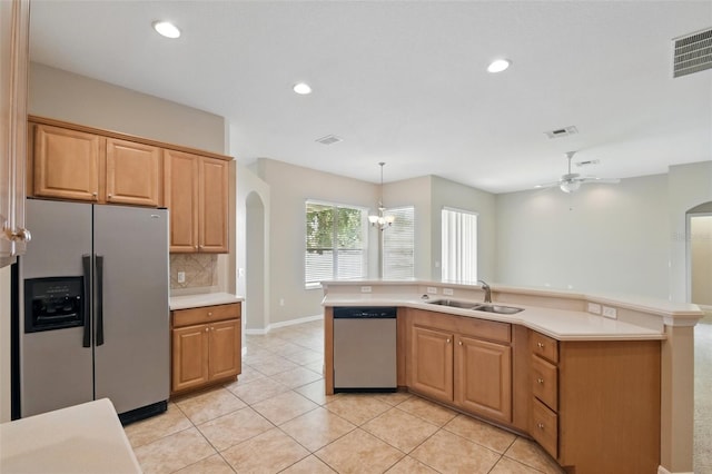 2674 Spicebush Loop, Apopka, FL 32712 - kitchen featuring refrigerator with ice dispenser, dishwasher, a sink, arched walkways, and light countertops