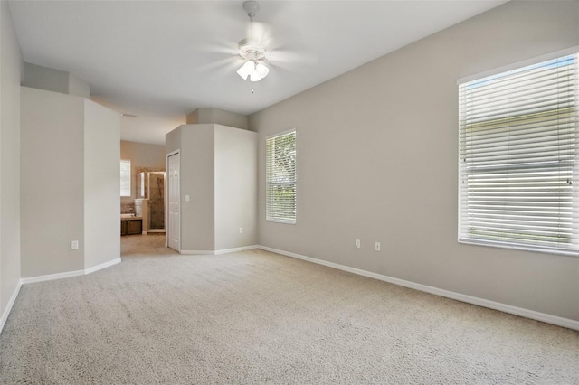 2674 Spicebush Loop, Apopka, FL 32712 - empty room with a ceiling fan, light carpet, baseboards, and plenty of natural light