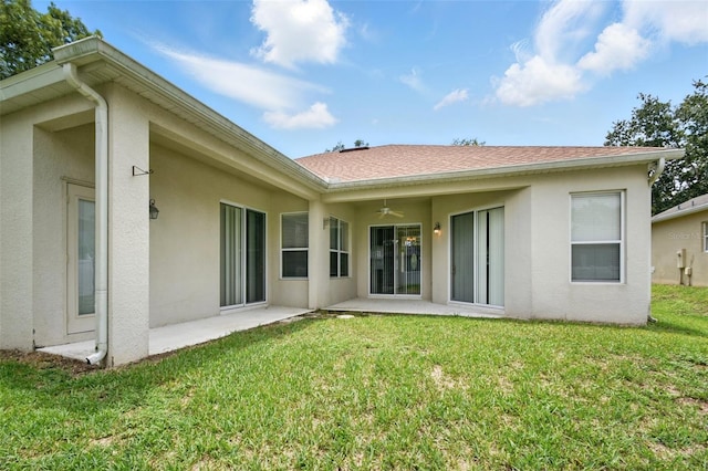 2674 Spicebush Loop, Apopka, FL 32712 - rear view of house with ceiling fan, a patio area, stucco siding, a lawn, and a shingled roof
