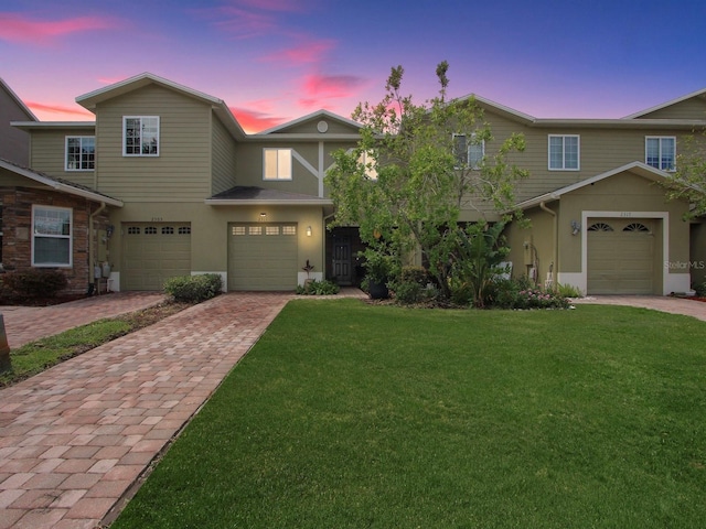 2311 Chatham Place Dr, Orlando, FL 32824 - townhome / multi-family property with driveway, a yard, and stucco siding