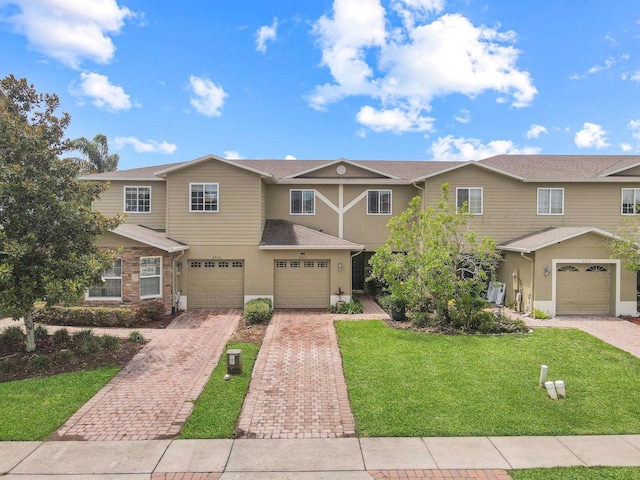 2311 Chatham Place Dr, Orlando, FL 32824 - multi unit property with driveway, a front lawn, stucco siding, and a garage