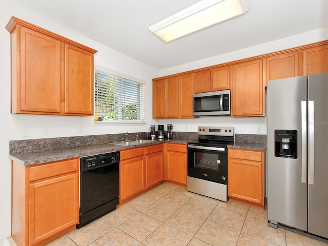 2311 Chatham Place Dr, Orlando, FL 32824 - kitchen featuring appliances with stainless steel finishes, a sink, dark countertops, light tile patterned floors, and brown cabinets