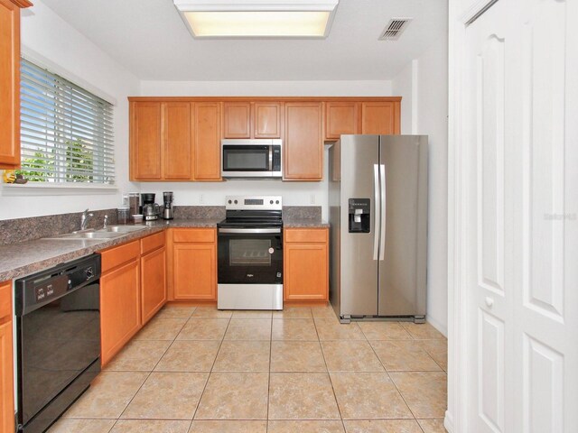 2311 Chatham Place Dr, Orlando, FL 32824 - kitchen with appliances with stainless steel finishes, a sink, dark countertops, and light tile patterned floors